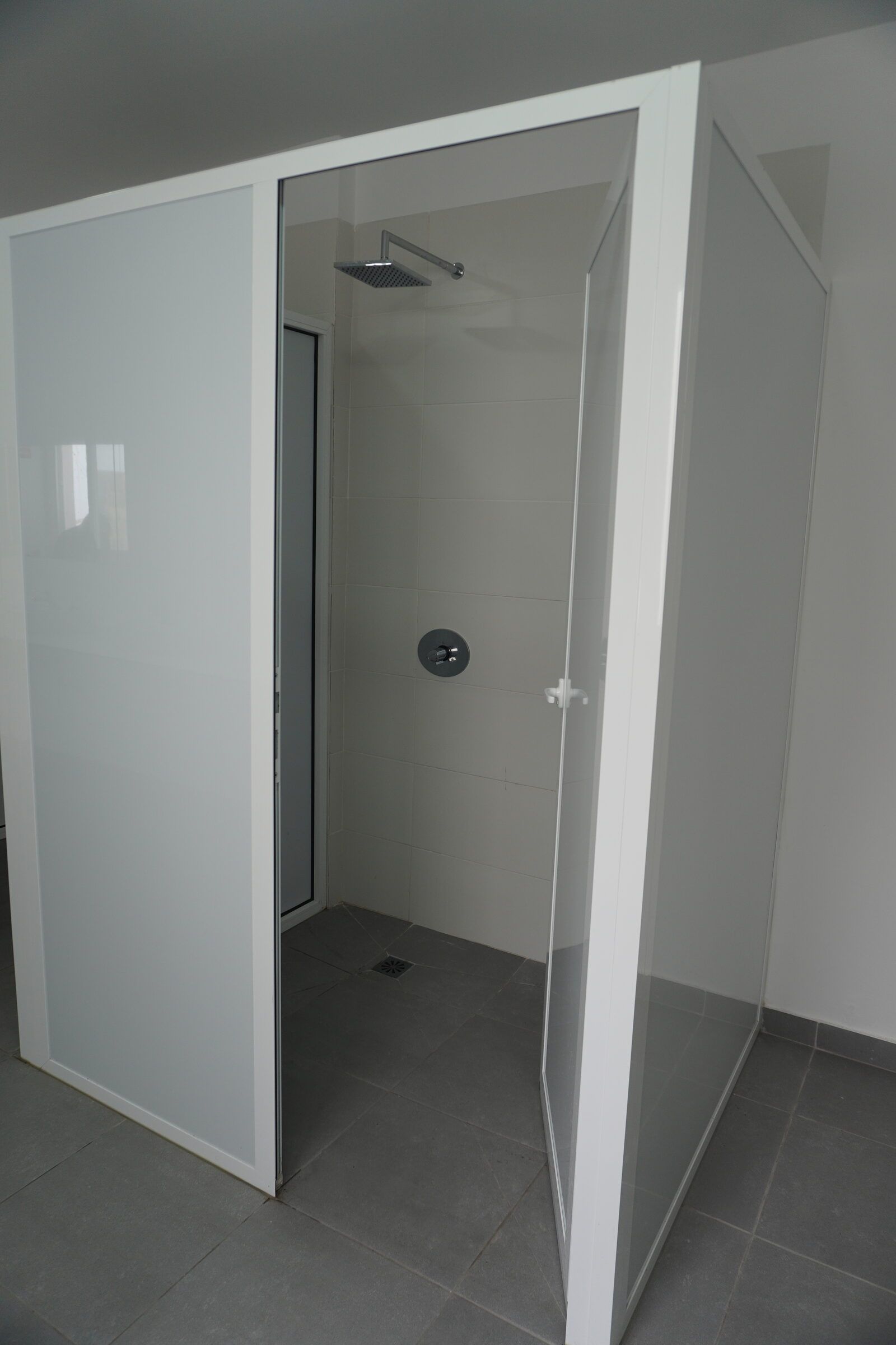 Shower cubicle with glass doors in the shared bathroom