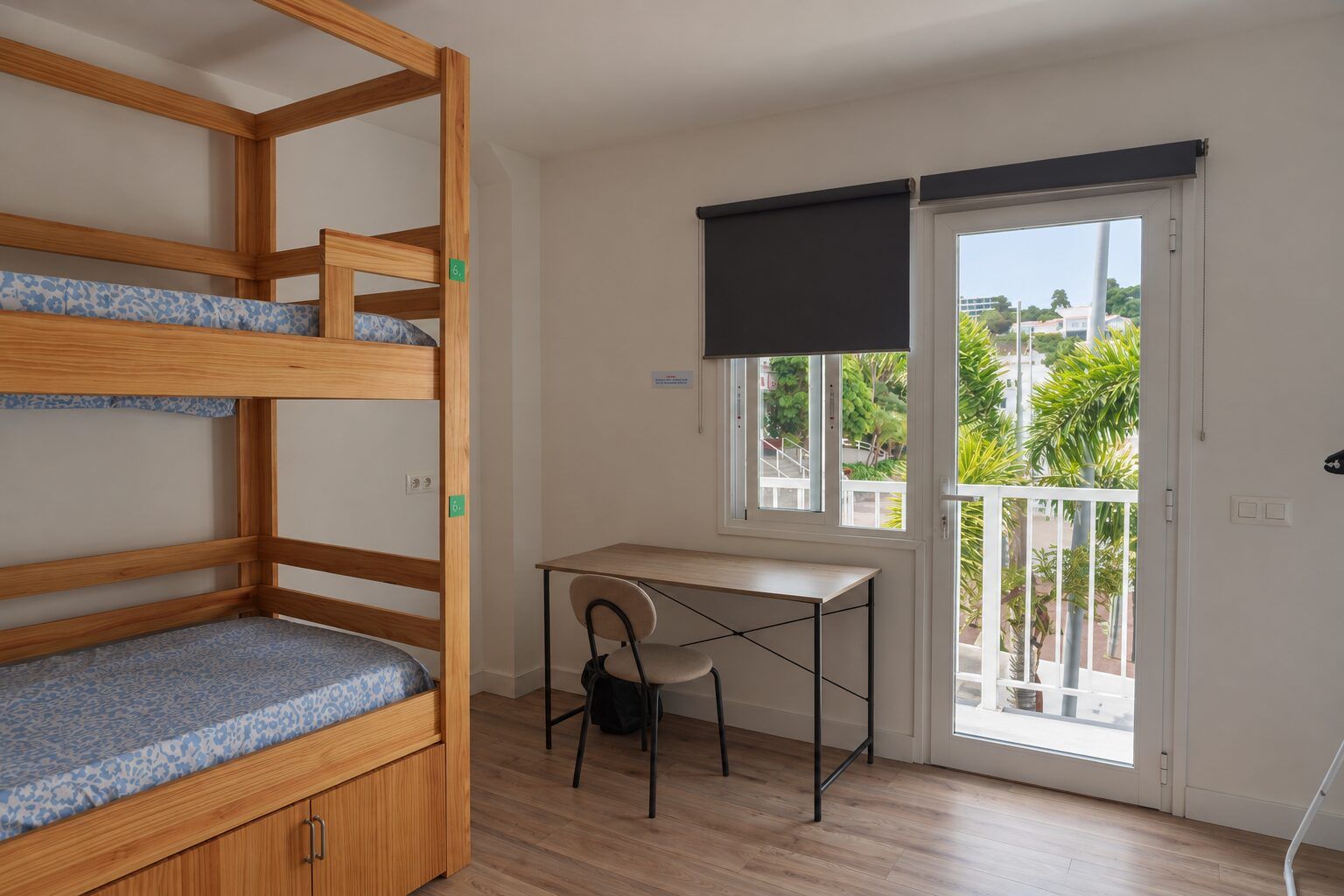 Room 6: bunk bed, desk and chair by the balcony door