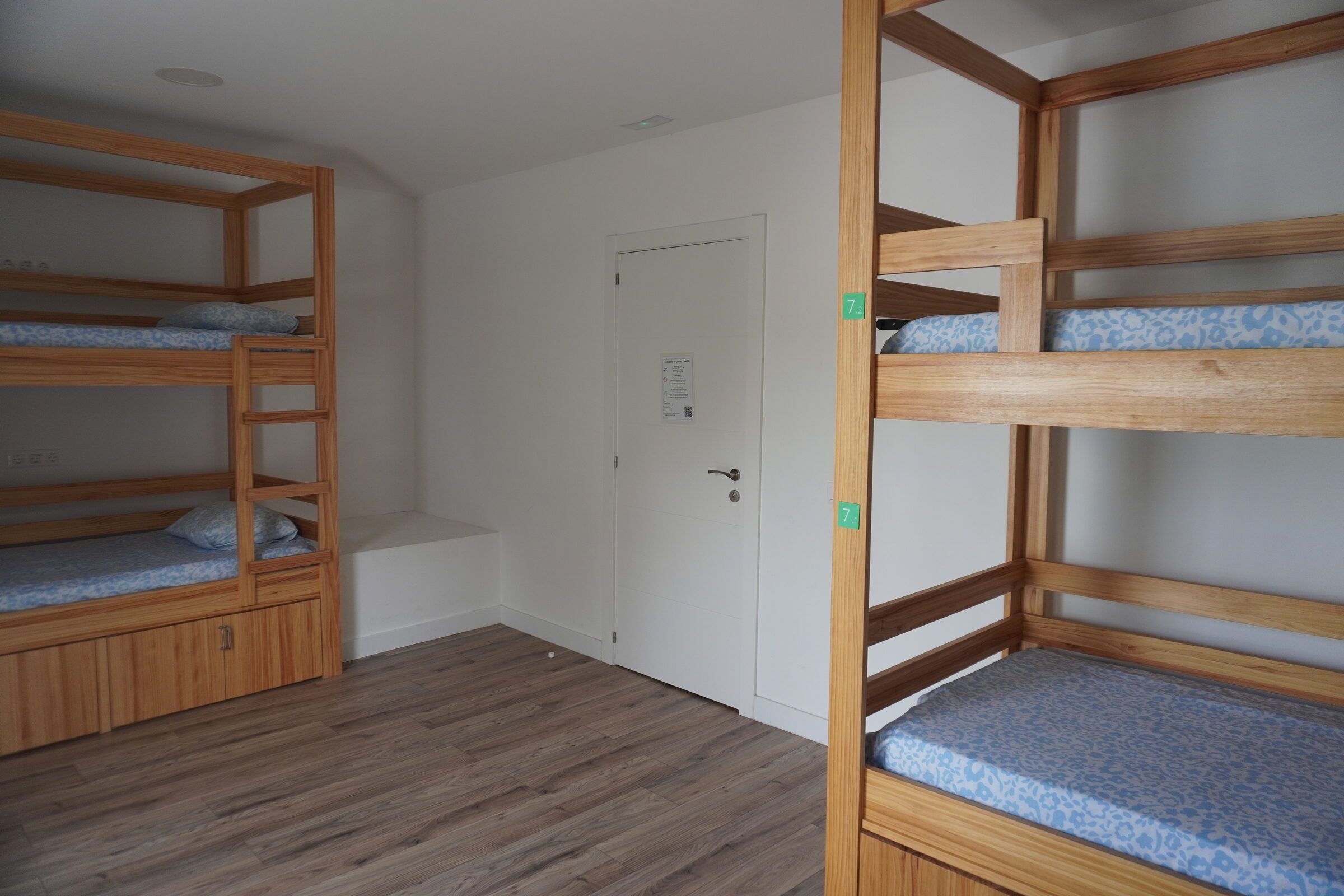 Room 7: two wooden bunk beds with storage drawers